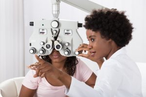 Eye Doctor performing an eye exam on a patient